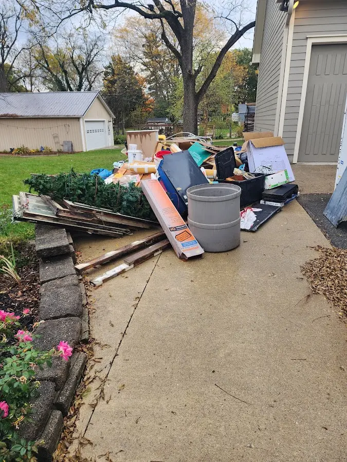 Dumpster being loaded with debris for Estate Cleanout Dumpster Rental in Medina